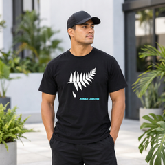 Model wearing the black Historical 94 Jonah Lomu memorial tee with fallen silver fern