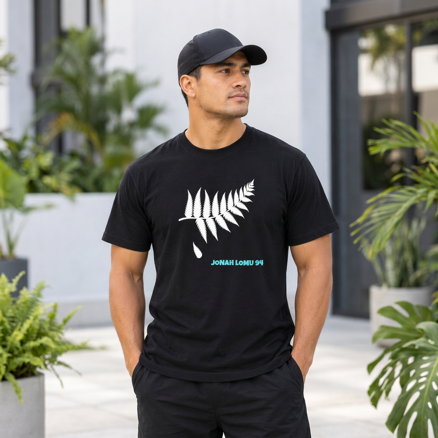 Model wearing the black Historical 94 Jonah Lomu memorial tee with fallen silver fern